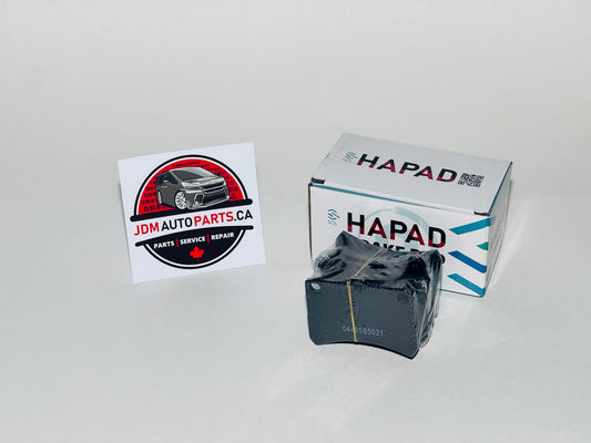 Car brake pads with HAPAD branding and JDM Auto Parts CA logo on a white background