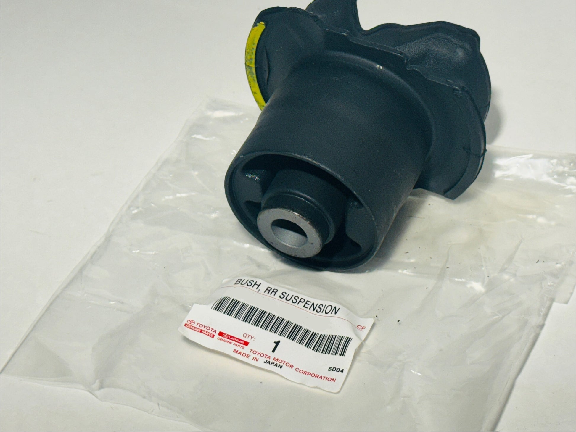 Black suspension bushing on a white background with a label