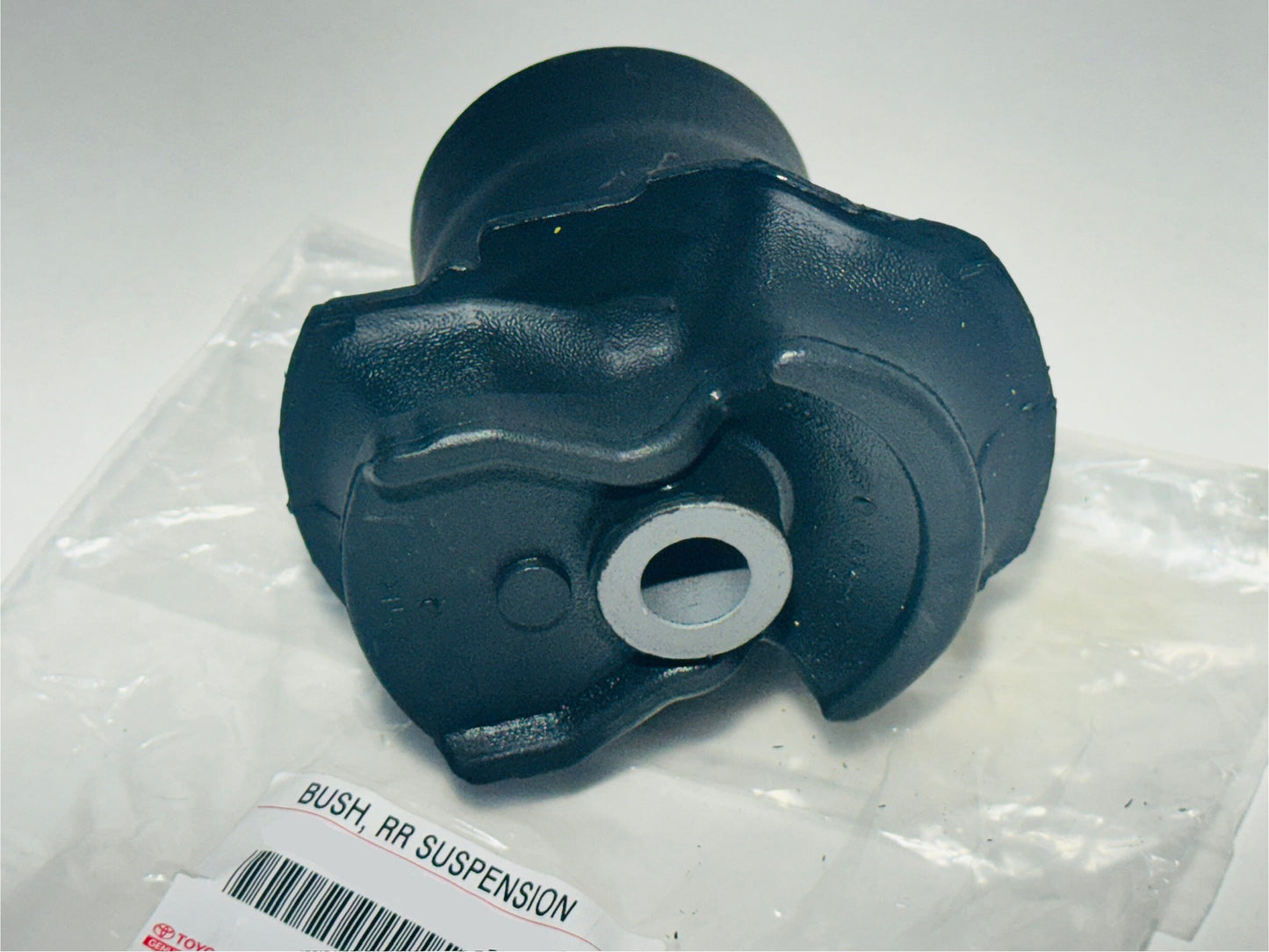 Black suspension bushing on a white background with a label