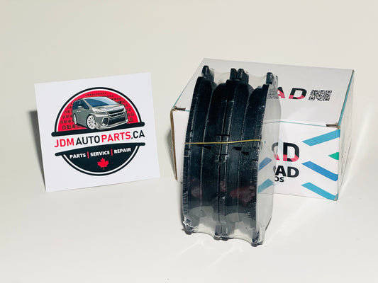 A set of Toyota Alphard brake pads made for 2002-2007 models with vin numbers starting with anh10 anh15 mnh10 mnh15 ath10 alongside the product packaging box with the JDMAutoParts.ca logo.