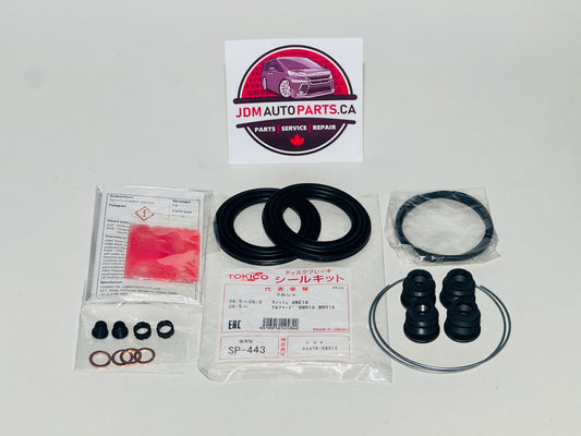 Automotive front caliper rebuild kit for Toyota Alphard with seals and gaskets on a white background, featuring JDM Auto Parts CA branding.