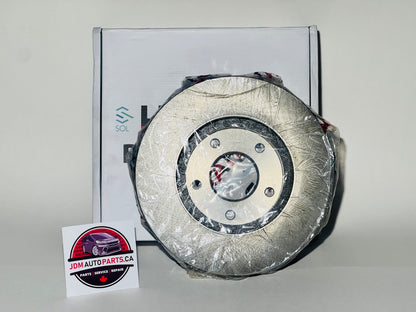 A new brake rotor packaged in plastic, displayed in front of a box with a label indicating the product is for a Nissan Elgrand E51 series.