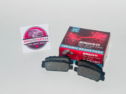 Ceramic brake pads with packaging and JDM Auto Parts CA logo on a gray background