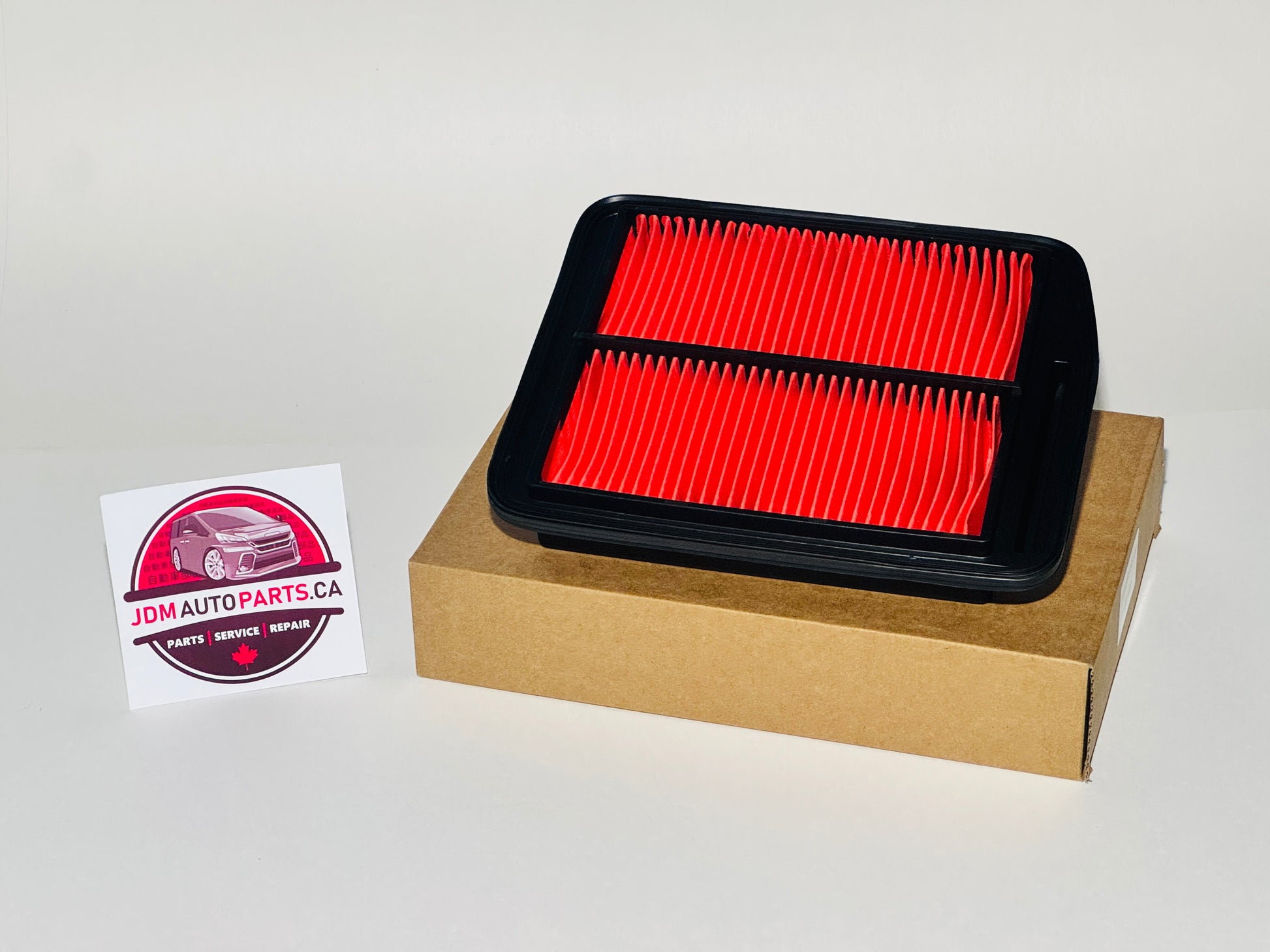 Red air filter on a cardboard box with JDM Auto Parts CA logo. 2003-2008 HONDA ODYSSEY JDM ENGINE AIR FILTER (RB1 / RB2)