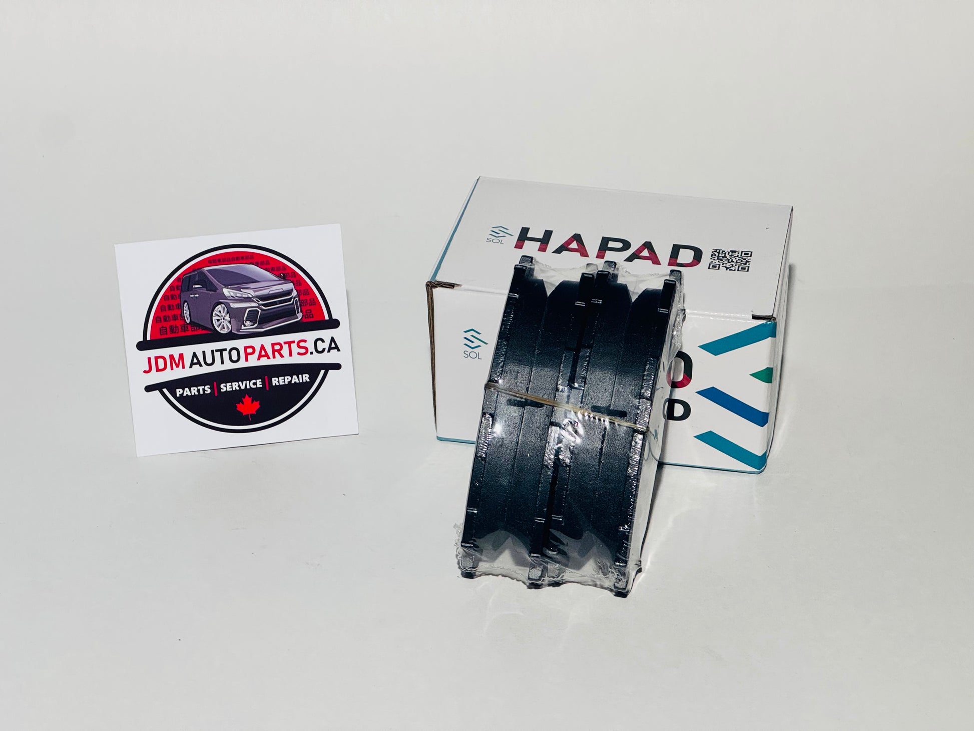 A set of Toyota blade brake pads displayed alongside the packaging box with the brand name visible.