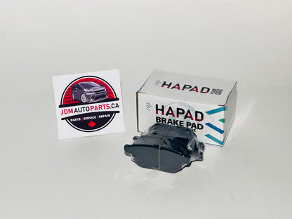 A set of Toyota blade brake pads displayed alongside the packaging box with the brand name visible.