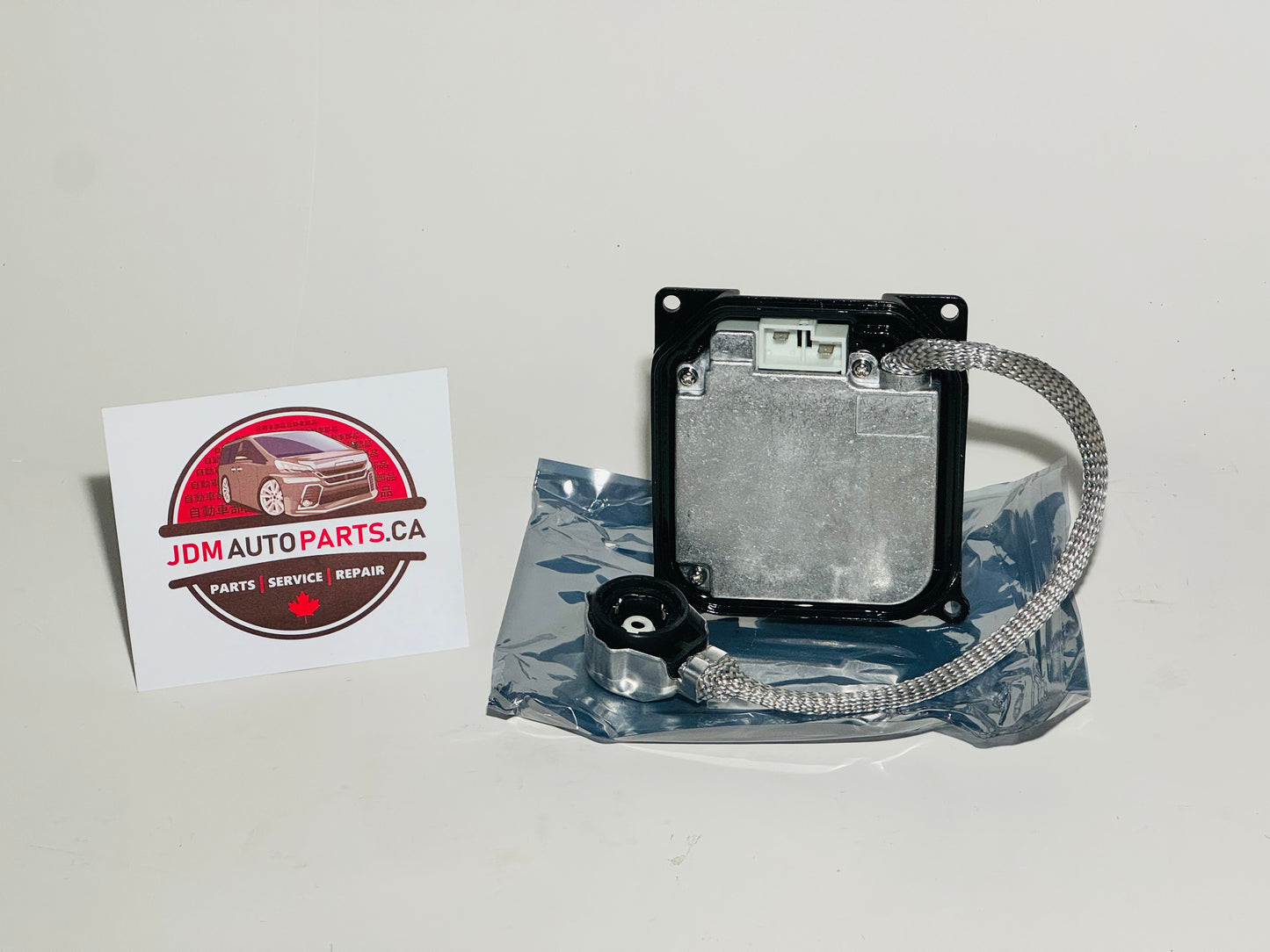 HID headlight ballast for Toyota Estima with wiring visible, placed on a branded JDM Auto Parts card.