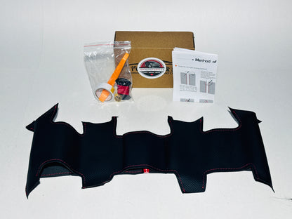 Black bat-shaped craft kit with supplies on a white background