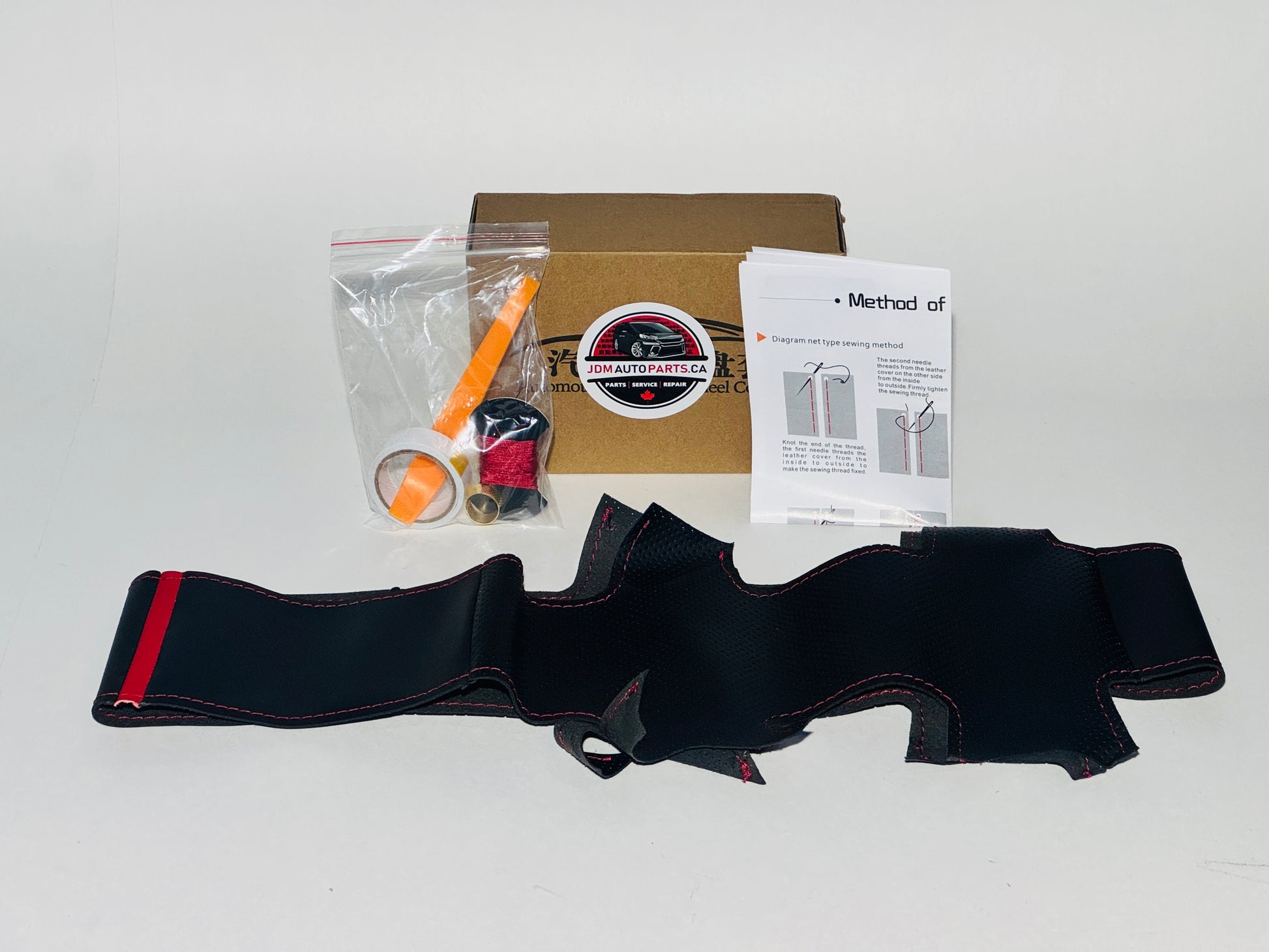 Black leather belt with red accent, packaging box, and instructions on a white background 2008-2014 TOYOTA ALPHARD / VELLFIRE CUSTOM CUT SEW-ON PREMIUM STEERING WHEEL COVER SIDE VIEW 