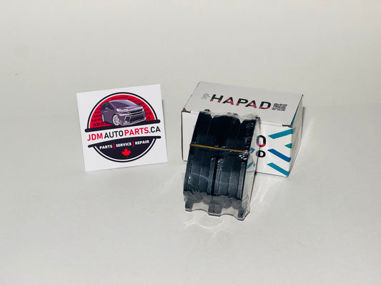 A set of Toyota Estima Hybrid brake pads with the product box and a JDM AUTO PARTS CA sticker in the background.
