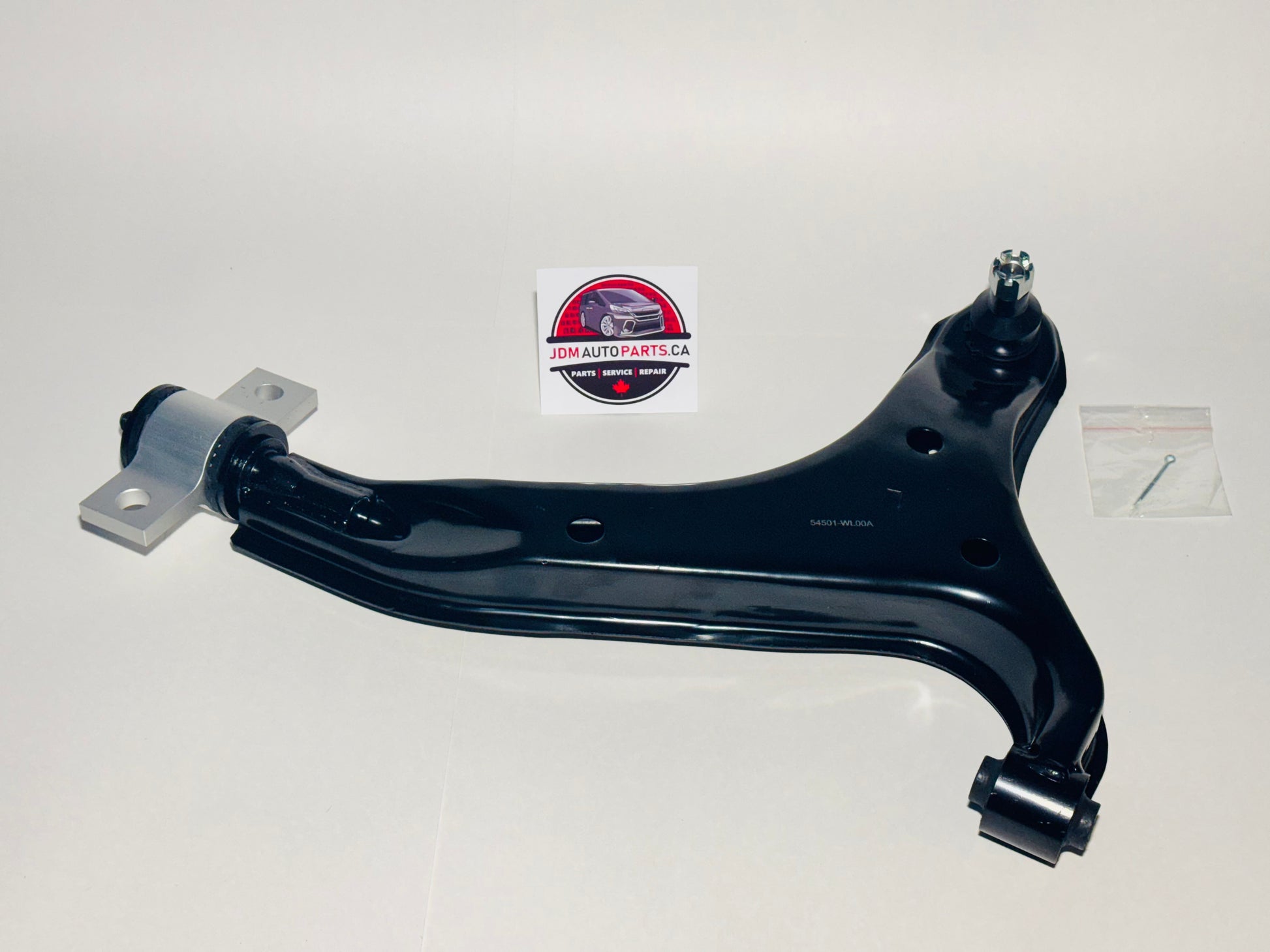 A black lower control arm for a Nissan Elgrand, displayed on a neutral background with a visible logo in the top right corner.