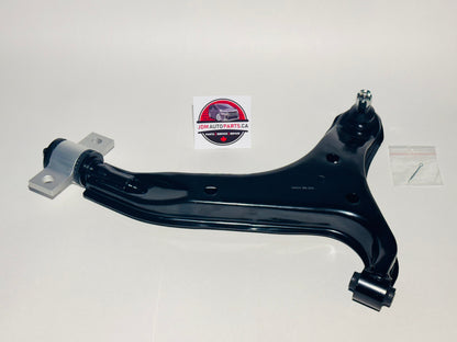A black lower control arm for a Nissan Elgrand, displayed on a neutral background with a visible logo in the top right corner.