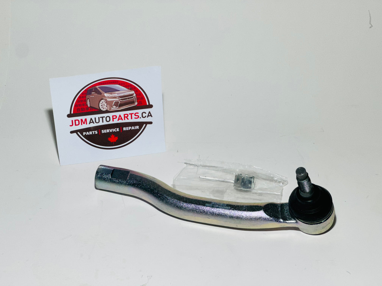 A silver tie rod end for a Toyota Alphard / Vellfires vehicle, displayed in front of a JDM Auto Parts Canada card.